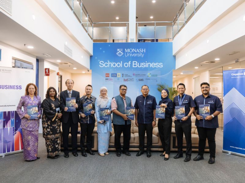 The School of Business research team and representatives from Cagamas Berhad pose for a group photo following the research launch.