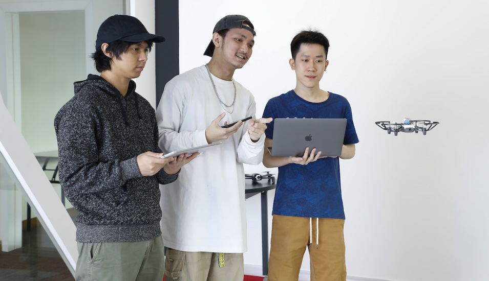 Monash Malaysia computer science students working with a drone