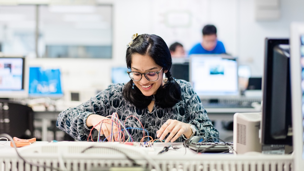 mechanical engineering student working on a technical project, designing a circuit