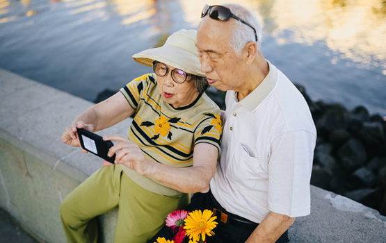 Aged couple taking photo