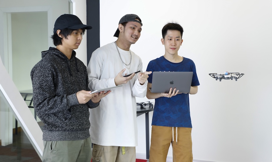 Monash IT students demonstrating drone technology in a lab
