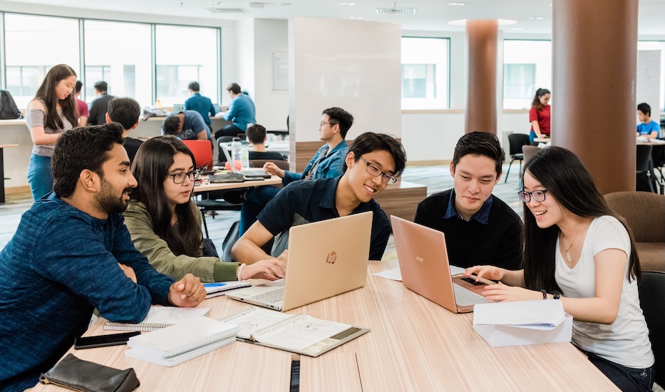 Students collaborating in a group study session at the library