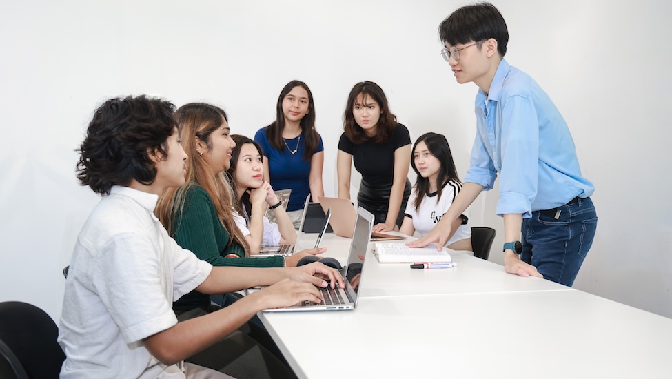Educational advisor discussing the education vs the work experience debate with university students
