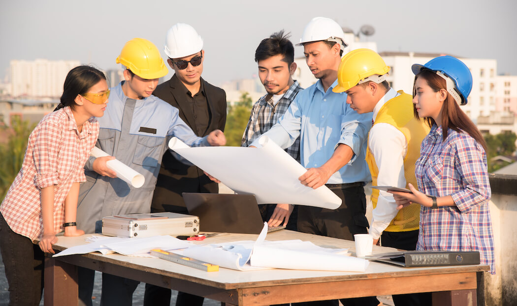 Group of Civil Engineers discussion at a construction site