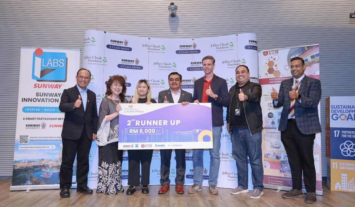 monash winner posing with mock cheque