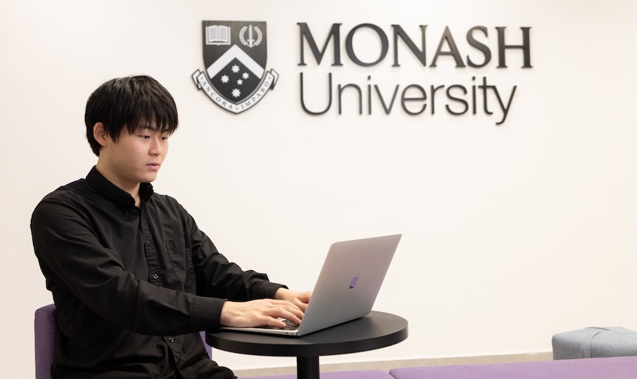 A Postgraduate Diploma student working on a laptop at Monash University Malaysia