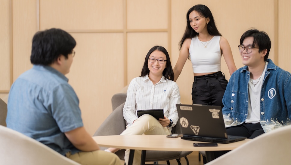 A group of master&rsquo;s students discussing in a study session