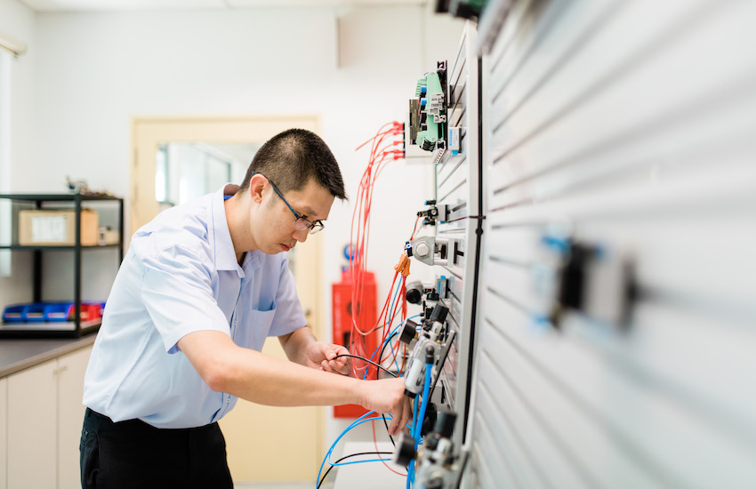 Electrical engineering student in lab doing experiments