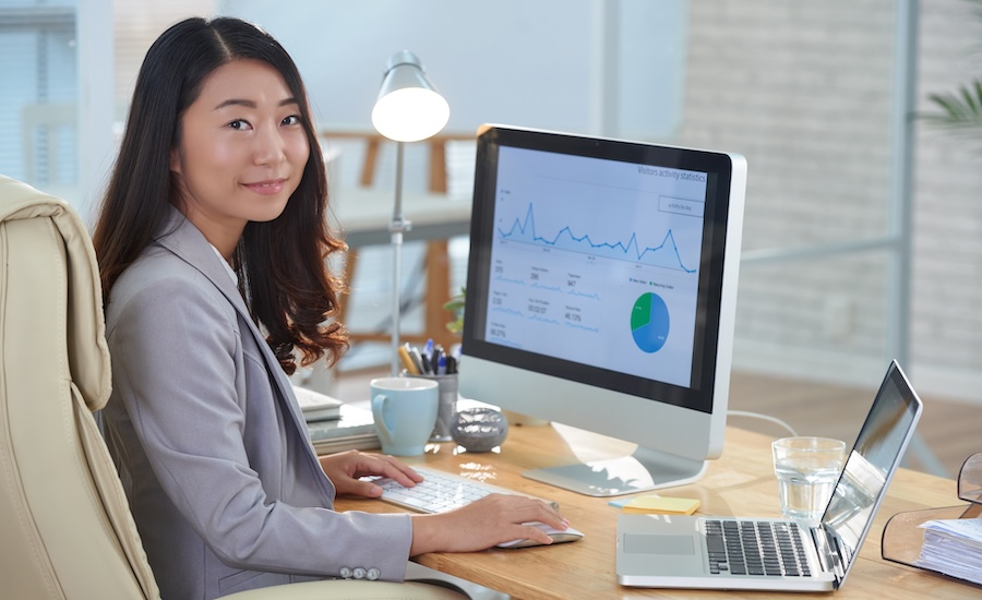 a data scientist analysing graphs and data on a computer