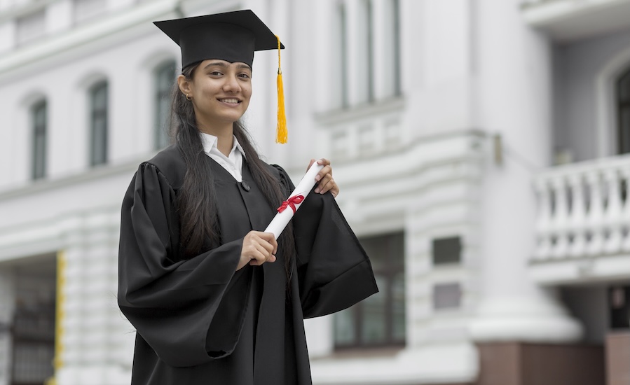 Graduate holding a certificate, celebrating the completion of a double major