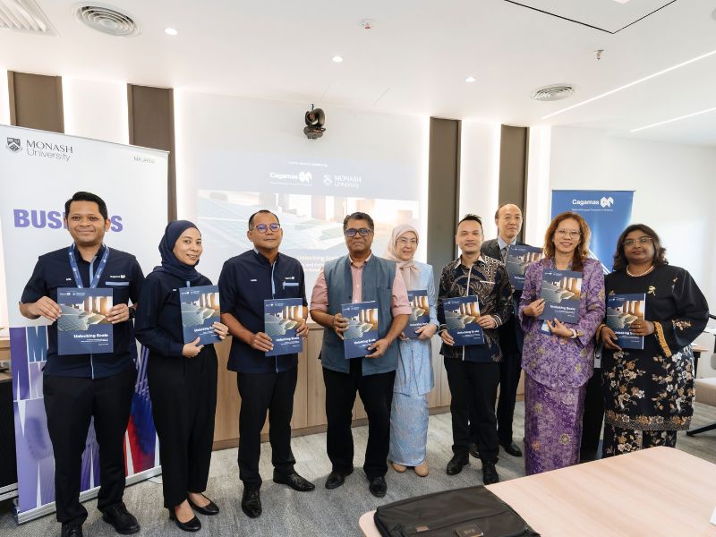 The School of Business research team and representatives from Cagamas Berhad pose for a group photo following the research launch.