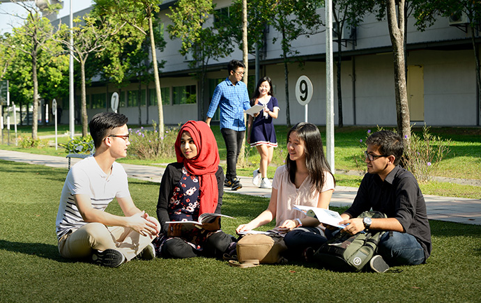 student sitting on grass student sitting on grass